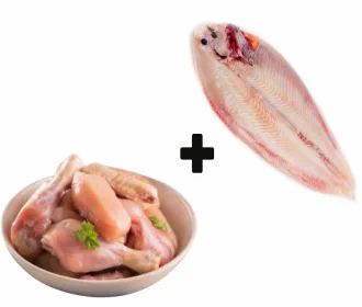 Bowl of chicken curry cut pieces next to a cleaned whole sole fish