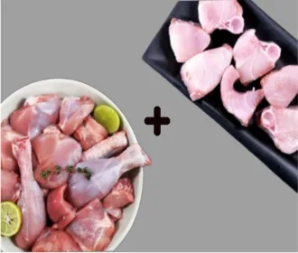 Chicken curry cut pieces with lime beside neymeen fish slices on a dark tray