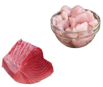 Fresh tuna loin beside a glass bowl of chicken fry cut cubes